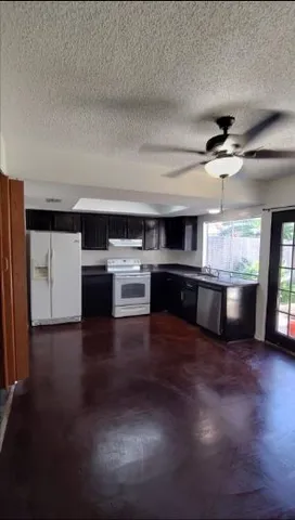 a kitchen with stainless steel appliances a stove top oven and a refrigerator