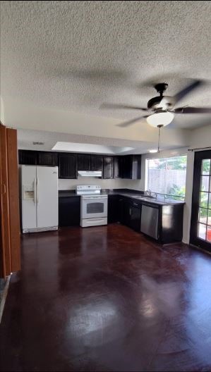 6432 Bankside Drive Houston, TX 77096 - Photo 6 of 14 a kitchen with stainless steel appliances a stove top oven and a refrigerator