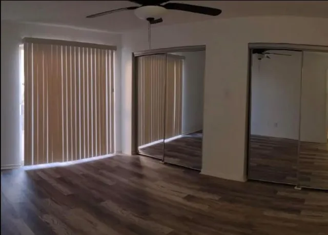a view of a room with wooden floor