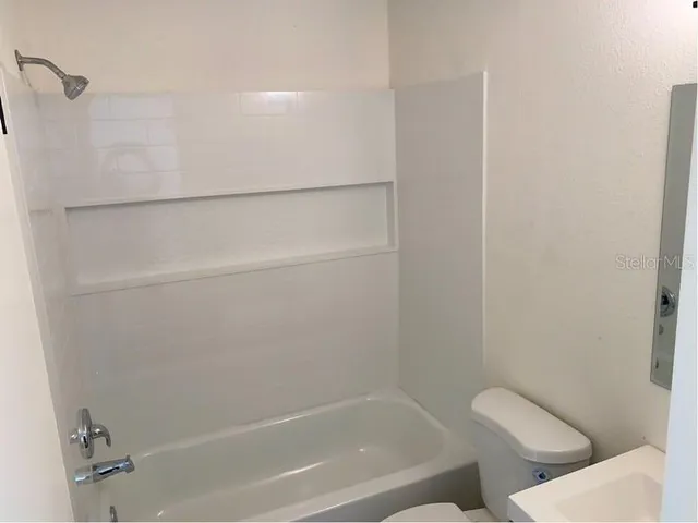a bathroom with a bathtub and toilet