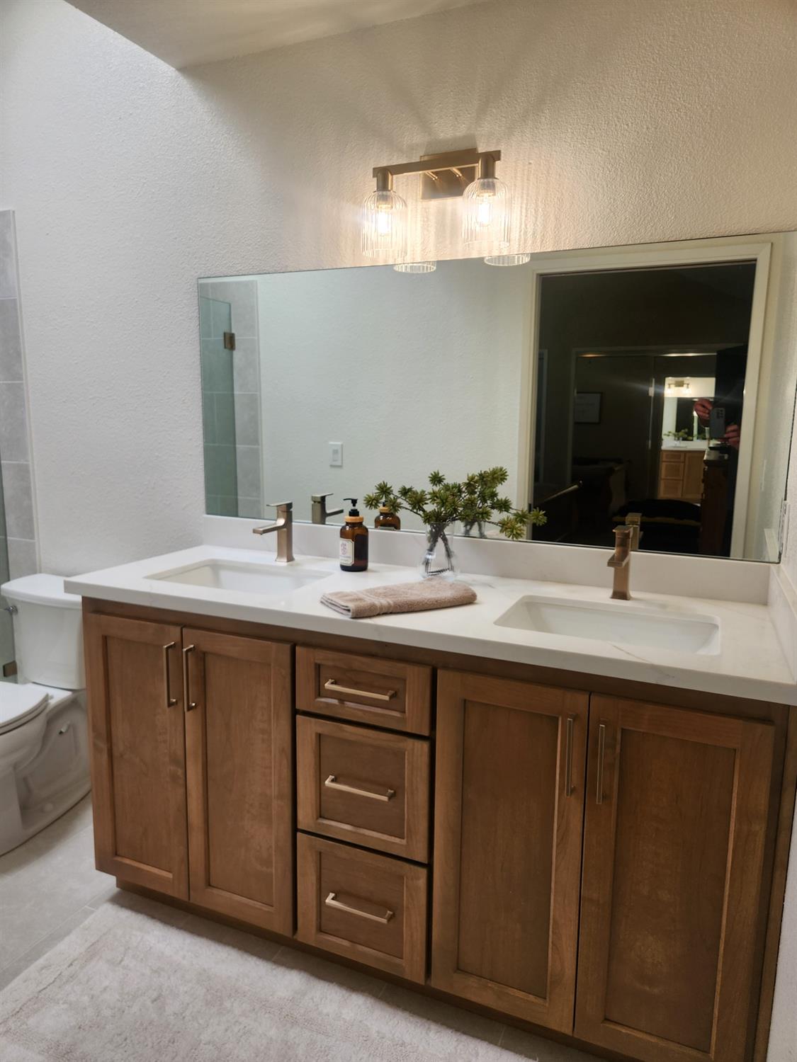 777 Jordanolo Drive Ripon, CA 95366 - Photo 34 of 61 a bathroom with a double vanity sink and a mirror
