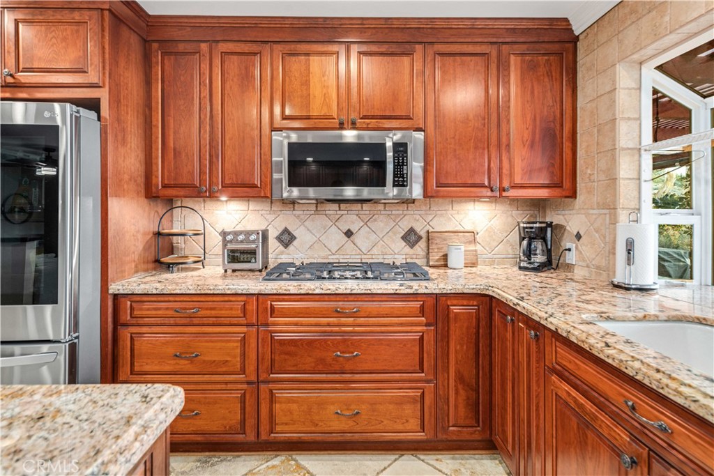 2862 Calmgarden Road Acton, CA 93510 - Photo 11 of 69 a kitchen with granite countertop a refrigerator and a sink