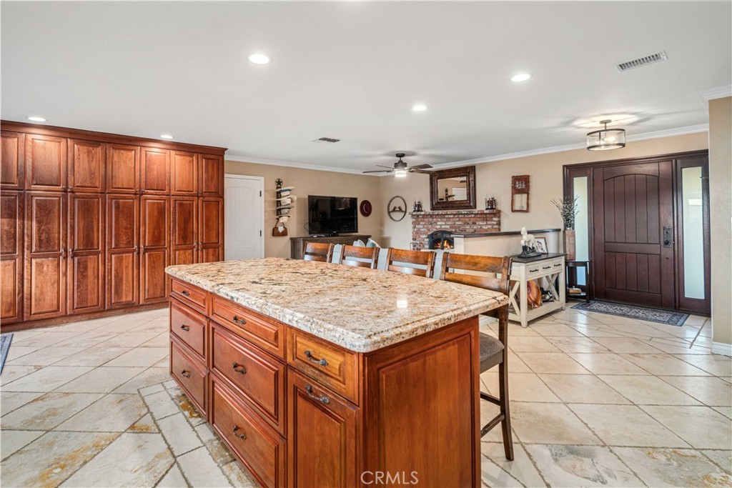 2862 Calmgarden Road Acton, CA 93510 - Photo 12 of 69 a kitchen with stainless steel appliances granite countertop a table chairs and a refrigerator