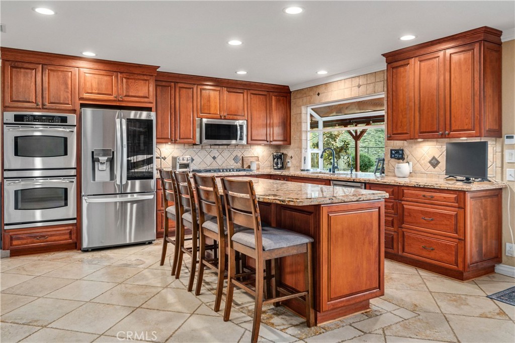 2862 Calmgarden Road Acton, CA 93510 - Photo 14 of 69 a kitchen with stainless steel appliances granite countertop a stove a microwave a sink and a refrigerator