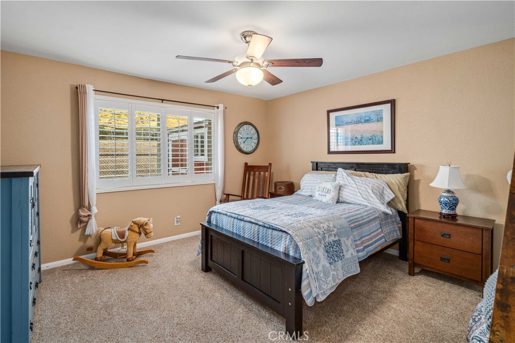 2862 Calmgarden Road Acton, CA 93510 - Photo 29 of 69 a spacious bedroom with a bed and a chandelier