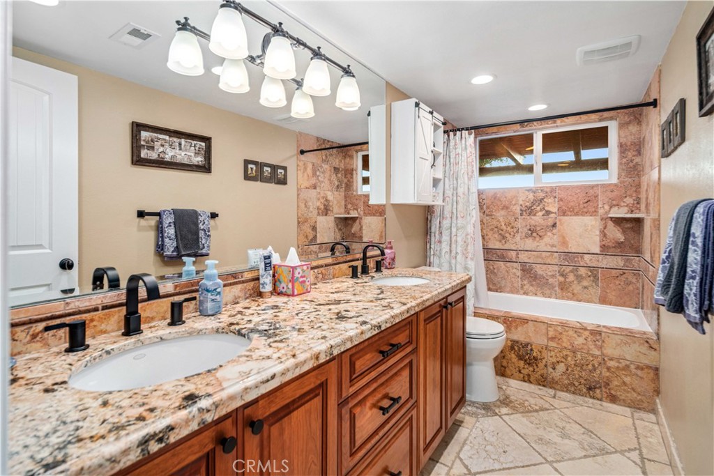 2862 Calmgarden Road Acton, CA 93510 - Photo 31 of 69 a bathroom with a granite countertop double vanity sink and mirror