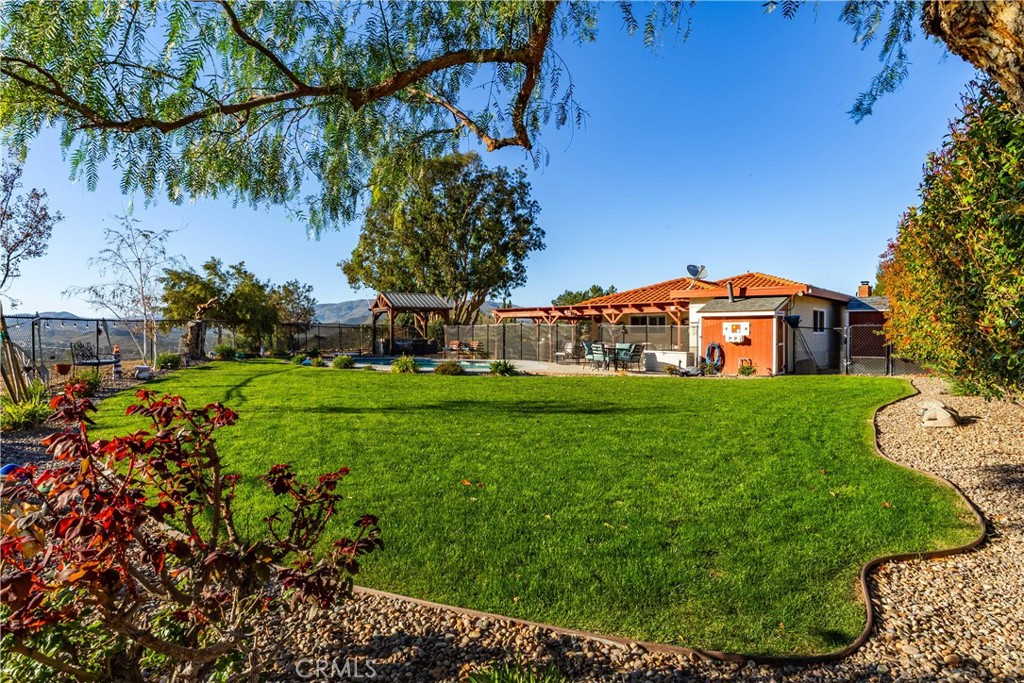 2862 Calmgarden Road Acton, CA 93510 - Photo 44 of 69 a view of a house with a big yard and large trees