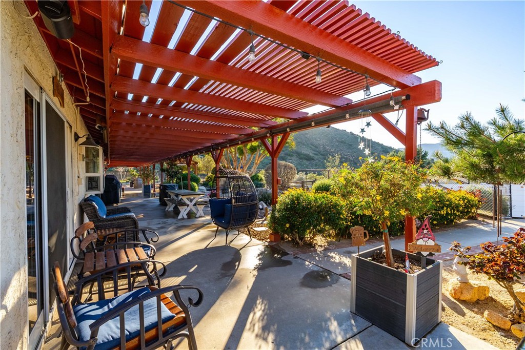 2862 Calmgarden Road Acton, CA 93510 - Photo 54 of 69 a view of a patio with table and chairs and potted plants
