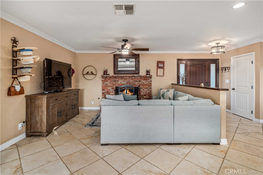 2862 Calmgarden Road Acton, CA 93510 - Photo 6 of 69 a living room with furniture a flat screen tv and a fireplace