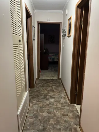 a view of a hallway with wooden floor and a hallway