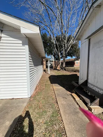 a view of backyard with wooden fence