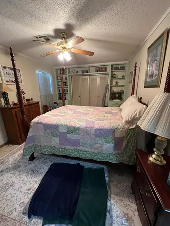 a bedroom with a bed and a mirror