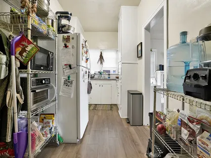 a view of a kitchen and an empty room