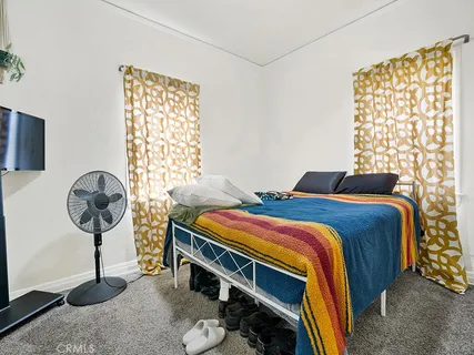 a bedroom with a bed and a window