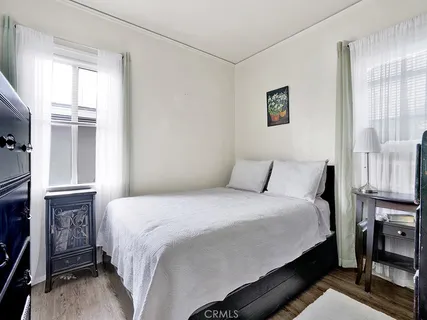 a bedroom with a bed and a night stand