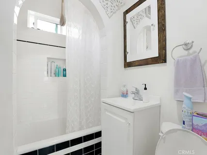 a bathroom with a sink vanity mirror and toilet