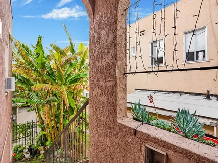 a view of a flower pot with wooden fence