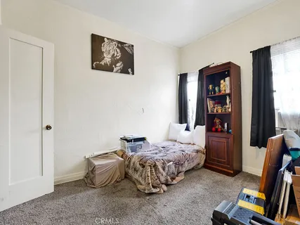 a bedroom with bed and a window