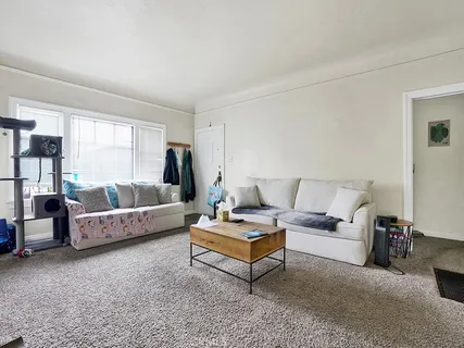 a living room with furniture and a large window