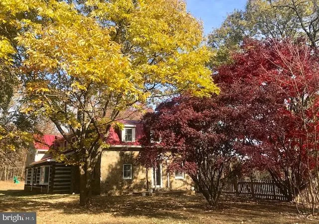 a front view of a house with a tree