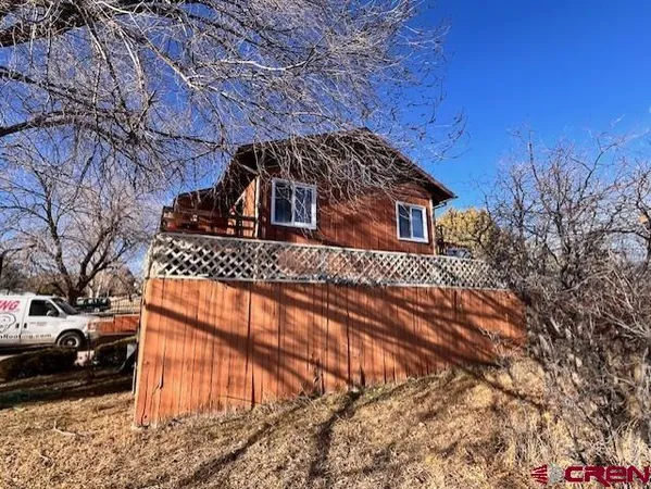 a front view of a house with parking area