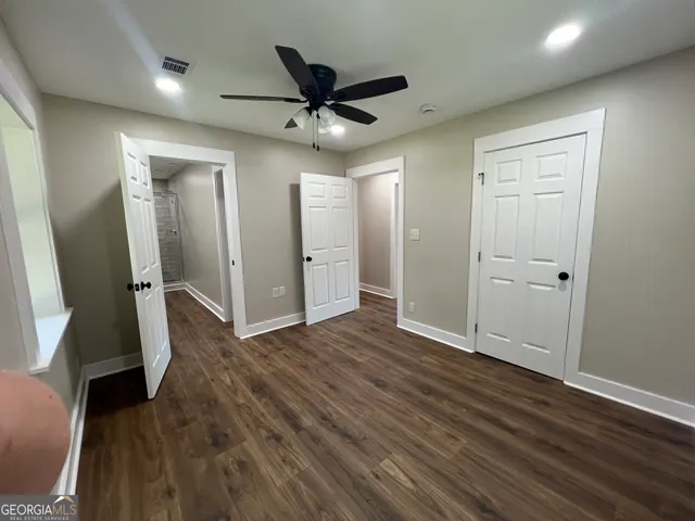 a bathroom with a double vanity sink a toilet and a mirror