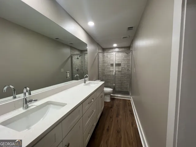 a bathroom with a glass door shower