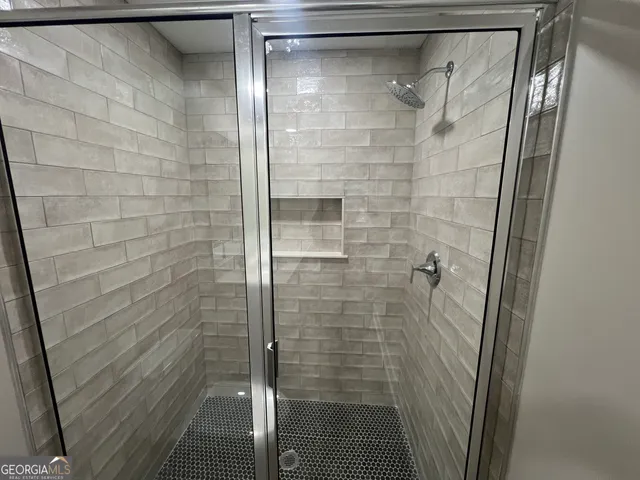 a bathroom with a double vanity sink toilet and a mirror