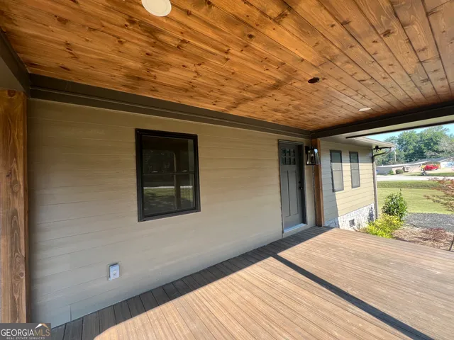 a view of a room with wooden floor and outdoor space