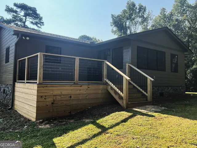 a house view with swimming pool in front of it