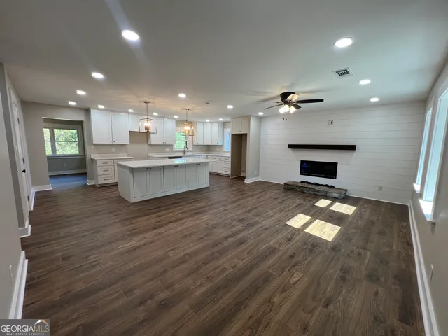 a view of kitchen with cabinets and wooden floor