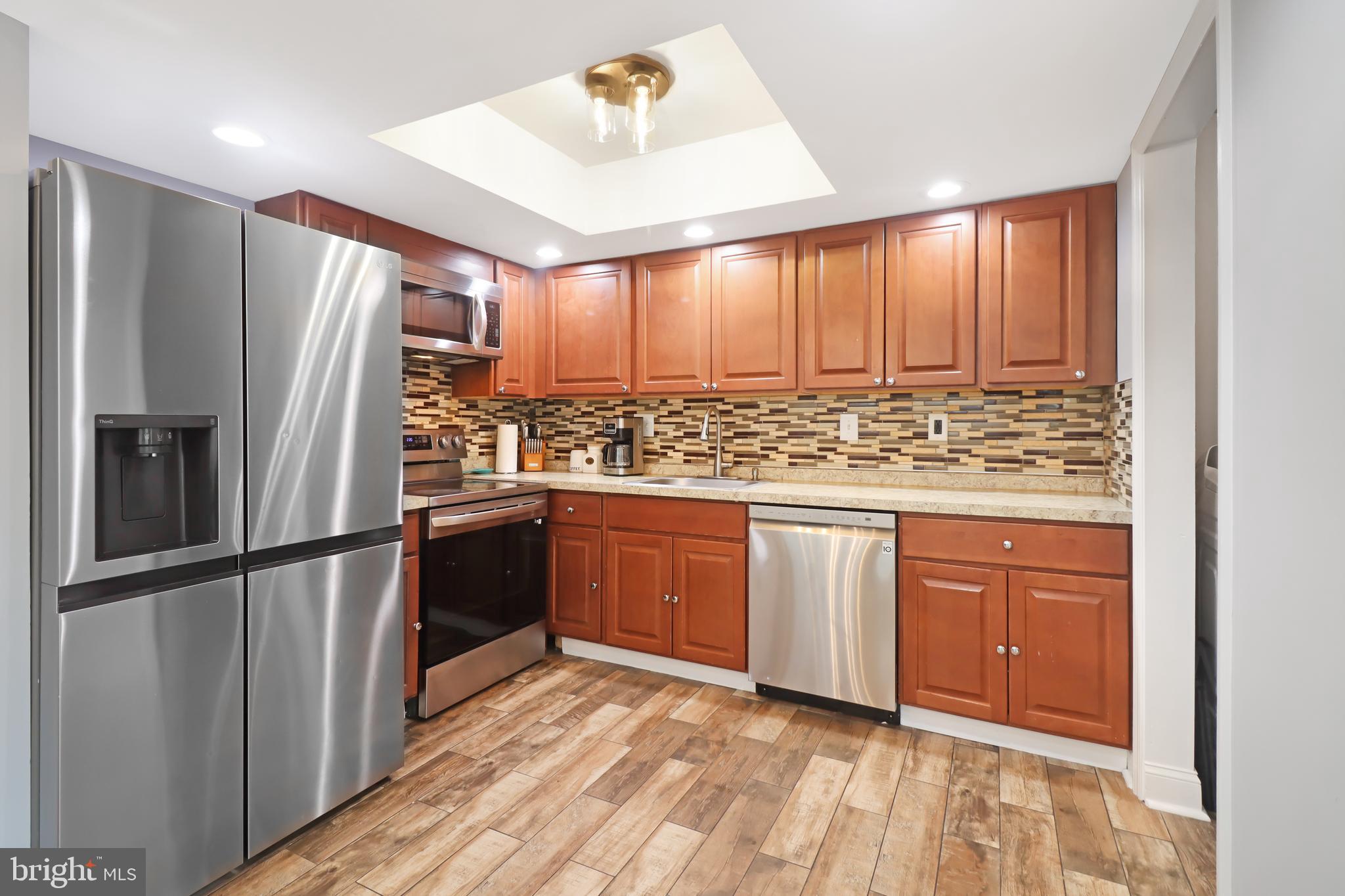 725 Myrtle Avenue Lindenwold, NJ 08021 - Photo 13 of 29 a kitchen with stainless steel appliances granite countertop a refrigerator and a sink