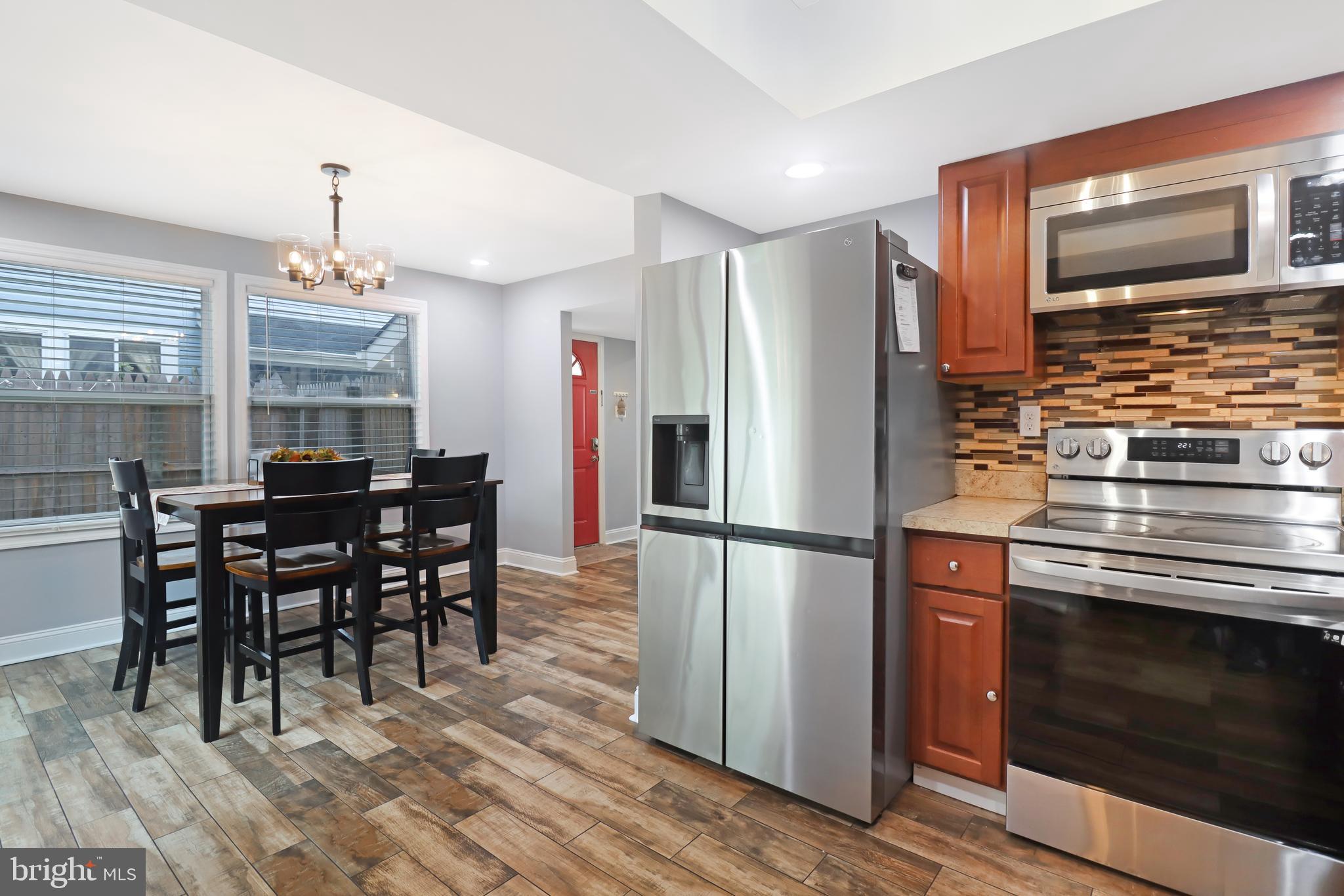 725 Myrtle Avenue Lindenwold, NJ 08021 - Photo 14 of 29 a kitchen with granite countertop a refrigerator stove top oven and cabinets