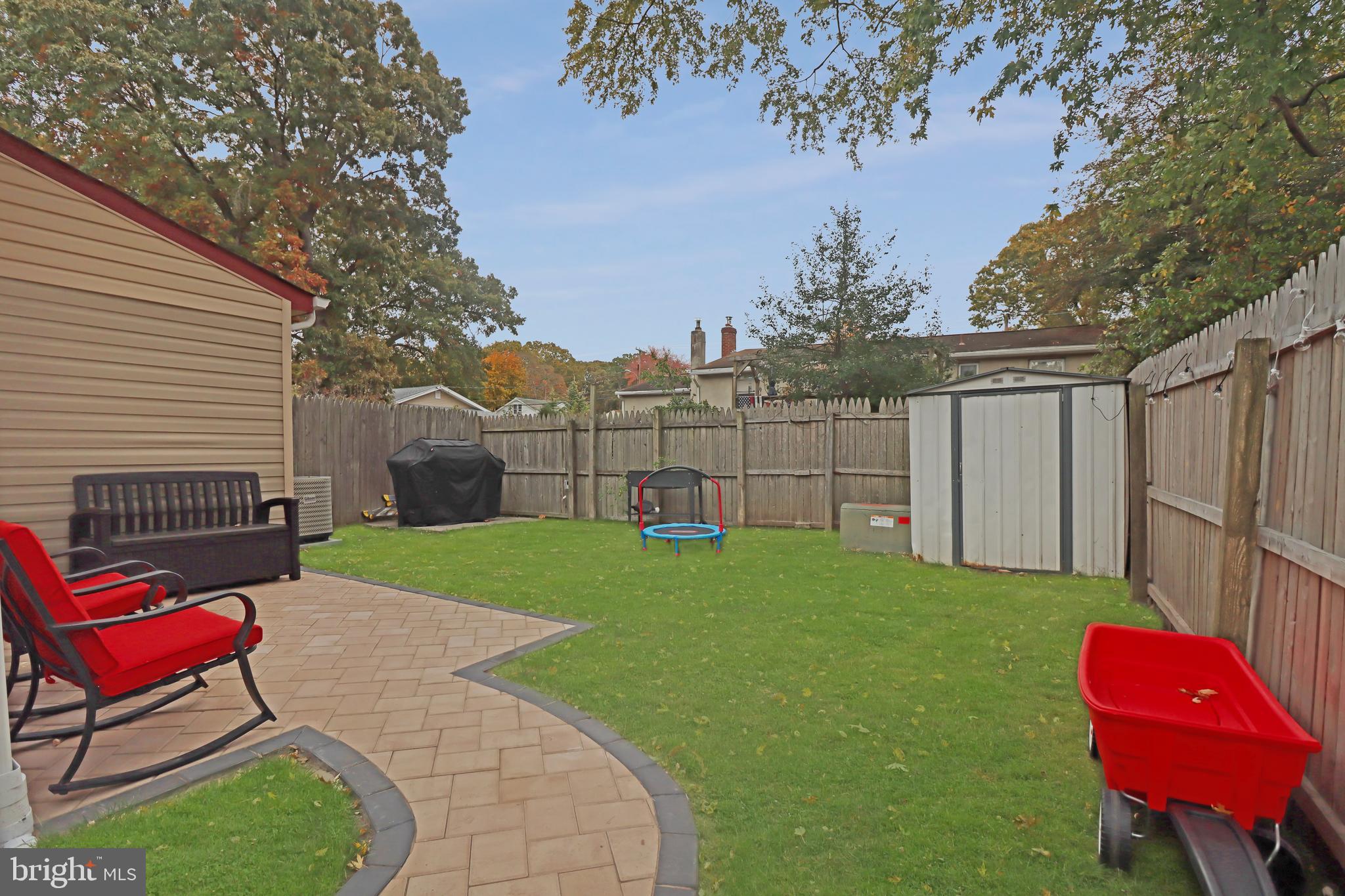 725 Myrtle Avenue Lindenwold, NJ 08021 - Photo 28 of 29 a view of a backyard with chair and a fire pit