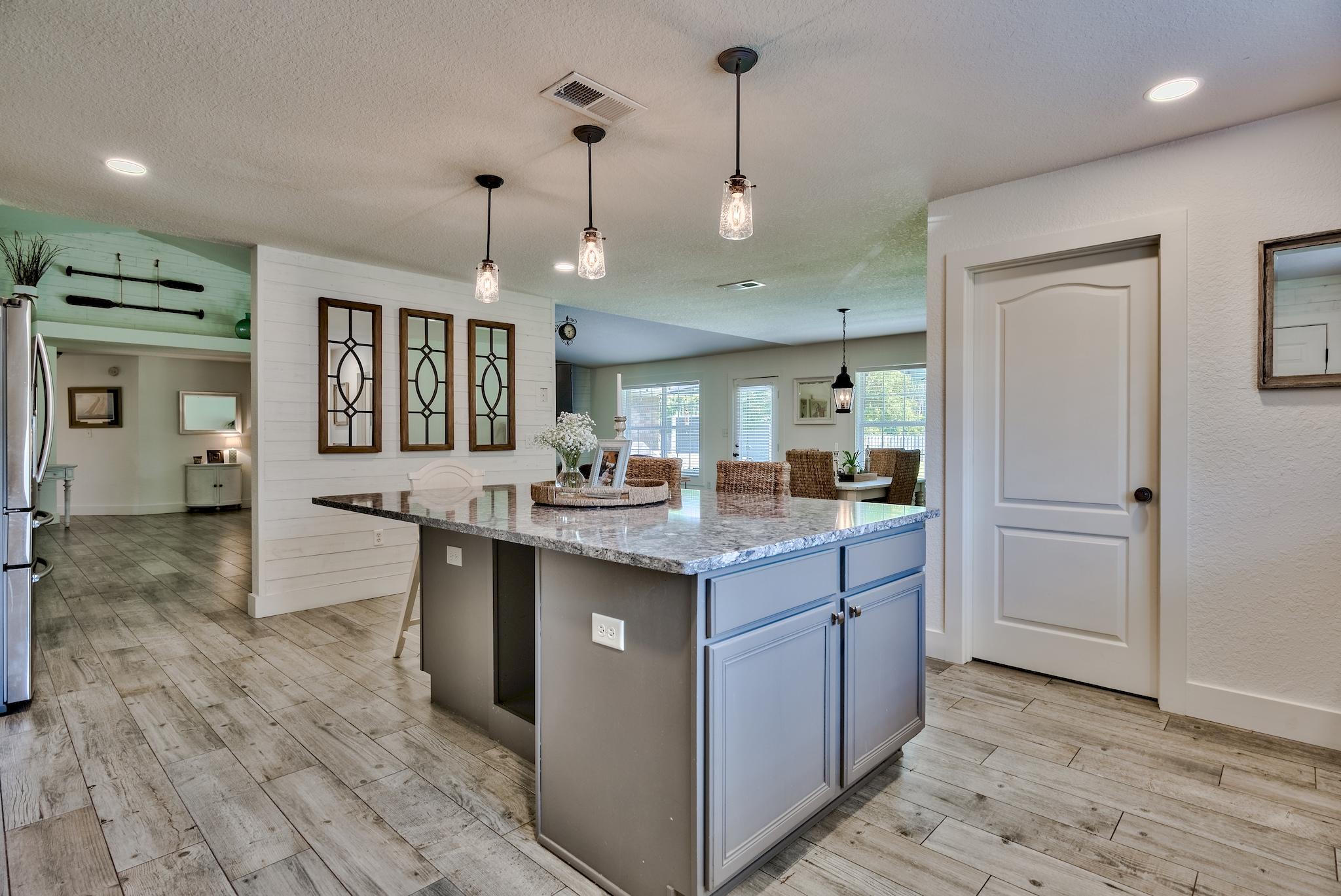 43 East Shipwreck Road Santa Rosa Beach, FL 32459 - Photo 11 of 40 a kitchen with granite countertop a sink and cabinets