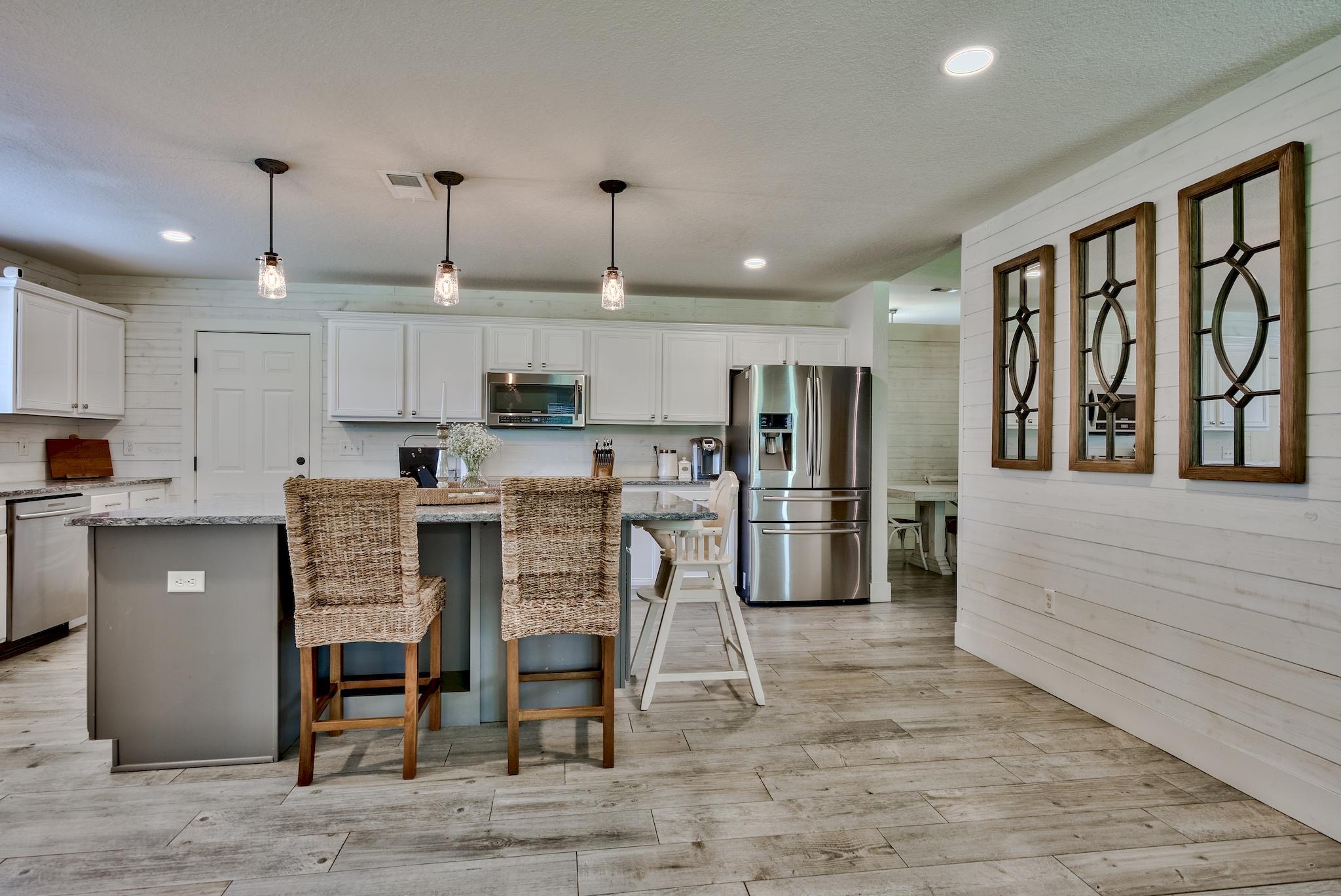43 East Shipwreck Road Santa Rosa Beach, FL 32459 - Photo 12 of 40 a kitchen with stainless steel appliances kitchen island granite top and refrigerator