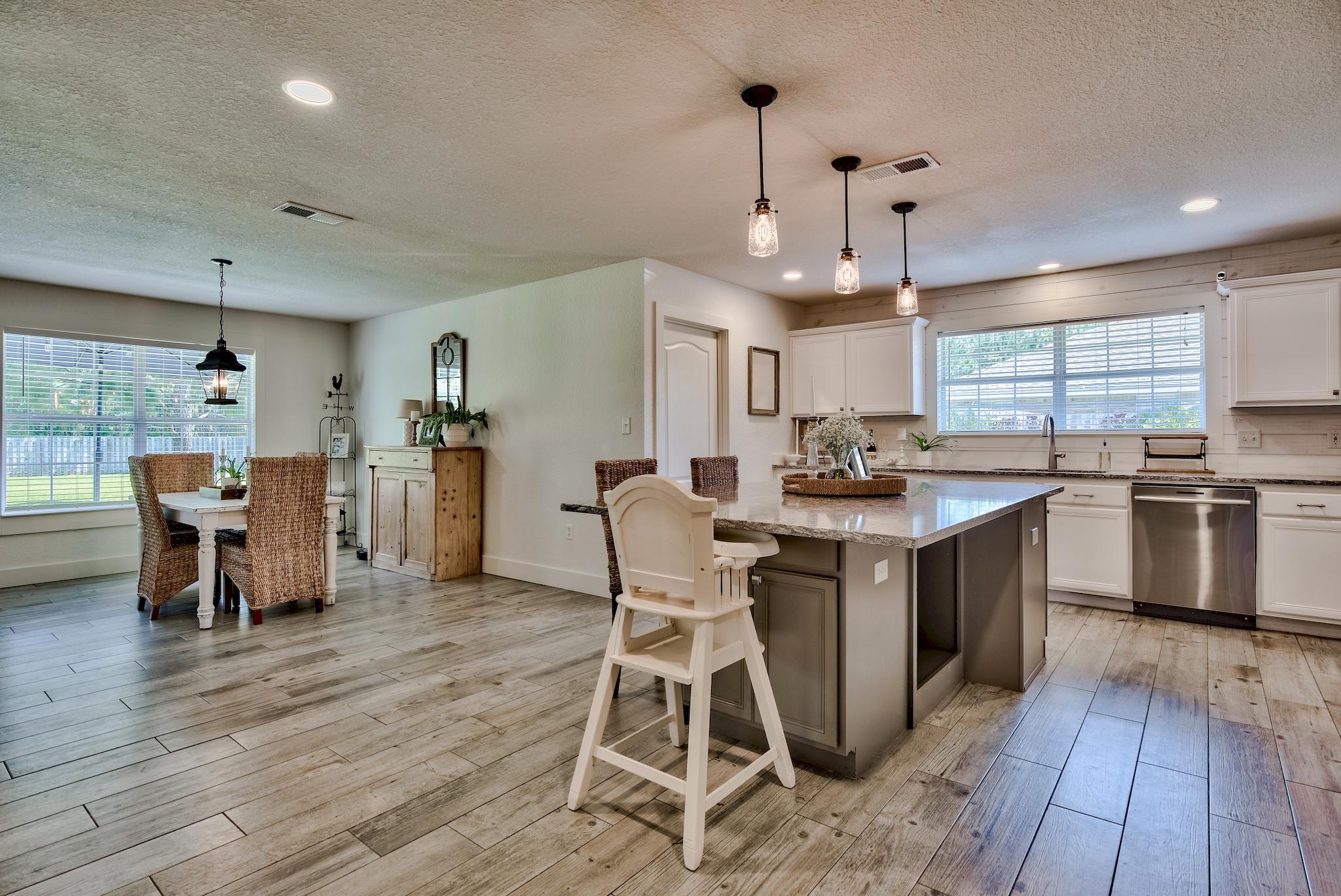 43 East Shipwreck Road Santa Rosa Beach, FL 32459 - Photo 13 of 40 a kitchen with stainless steel appliances a dining table chairs stove refrigerator and cabinets
