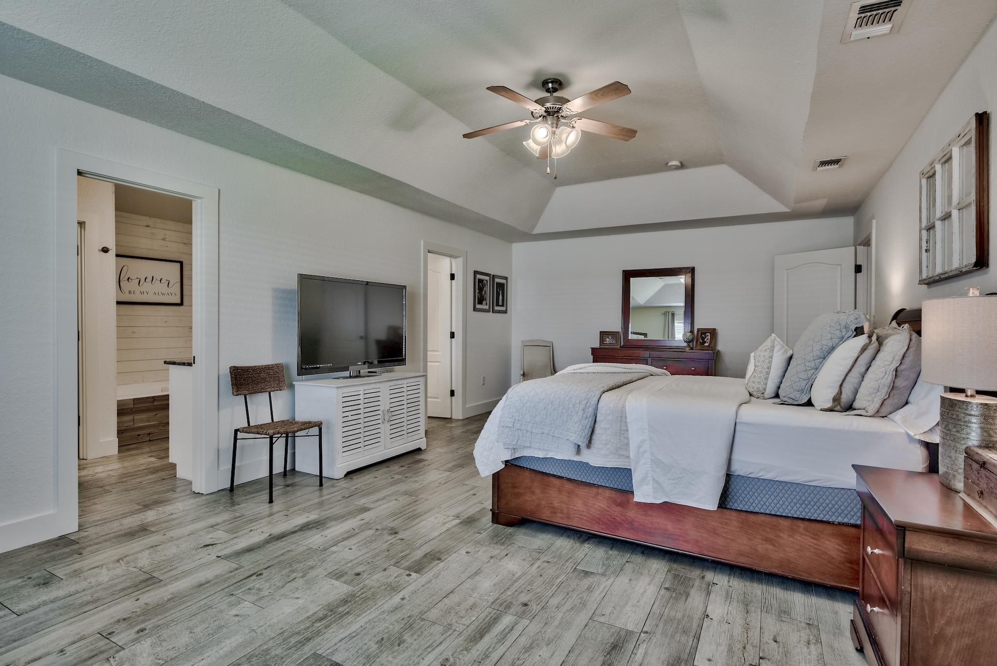 43 East Shipwreck Road Santa Rosa Beach, FL 32459 - Photo 20 of 40 a spacious bedroom with a bed and a flat screen tv