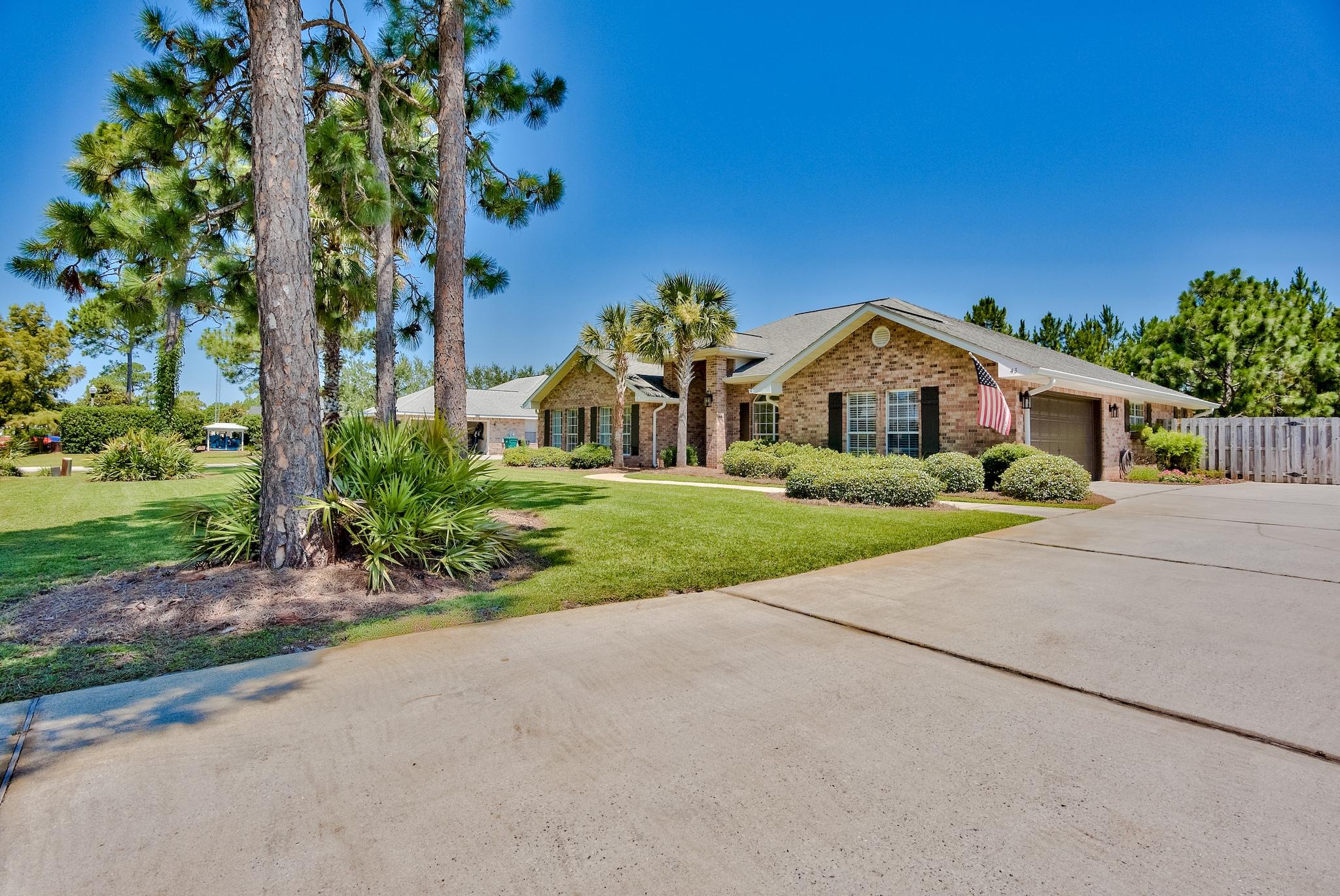 43 East Shipwreck Road Santa Rosa Beach, FL 32459 - Photo 2 of 40 a front view of a house with a yard and garage
