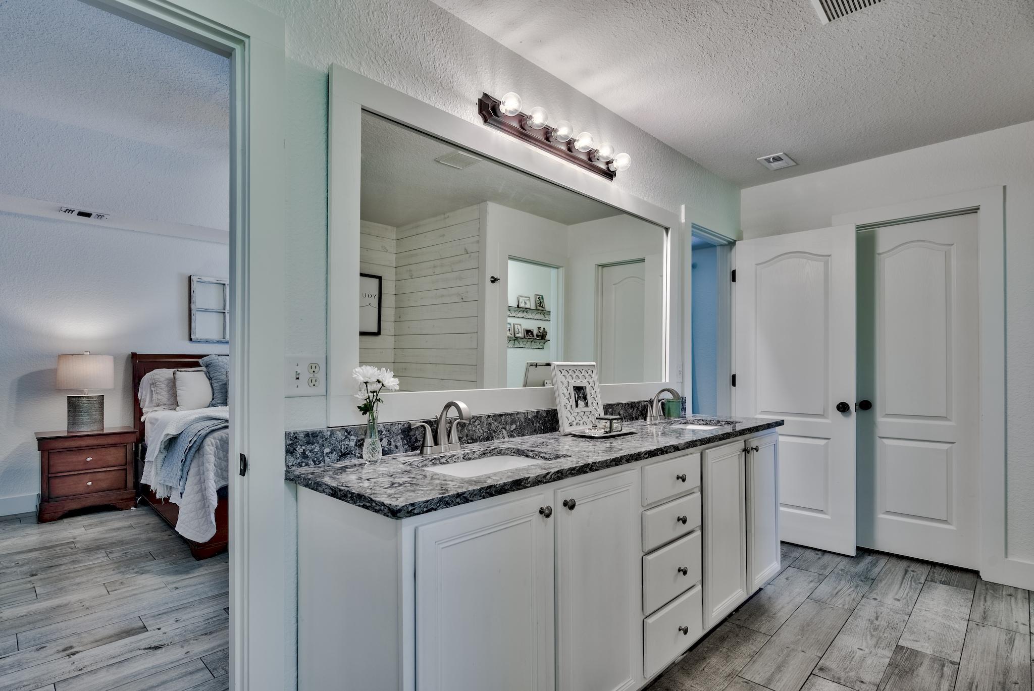 43 East Shipwreck Road Santa Rosa Beach, FL 32459 - Photo 21 of 40 a bathroom with a granite countertop double vanity sink and a mirror