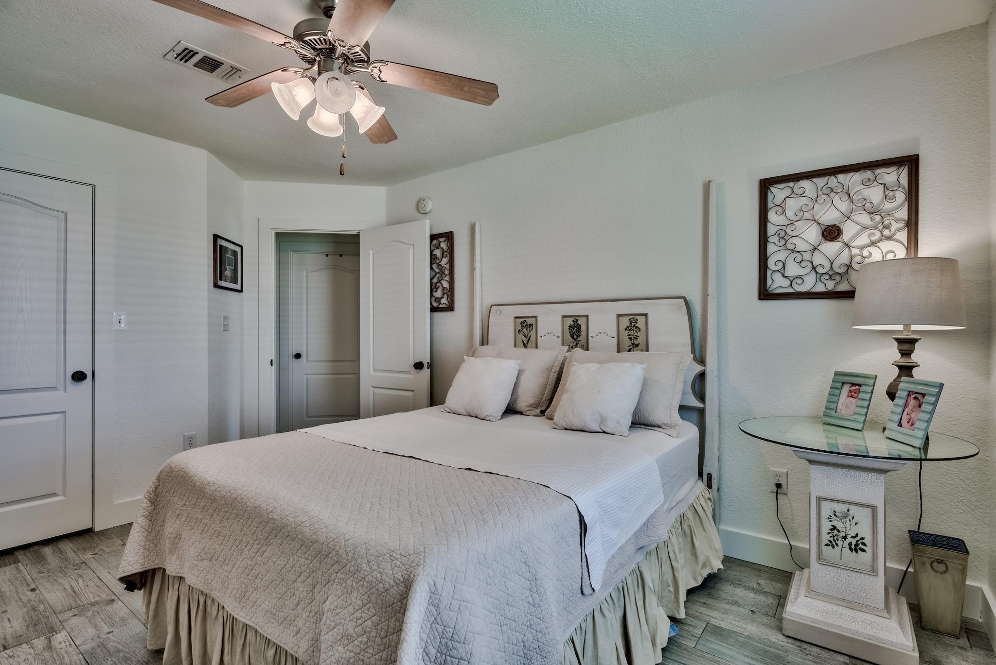 43 East Shipwreck Road Santa Rosa Beach, FL 32459 - Photo 25 of 40 a bedroom with a large bed and a chandelier