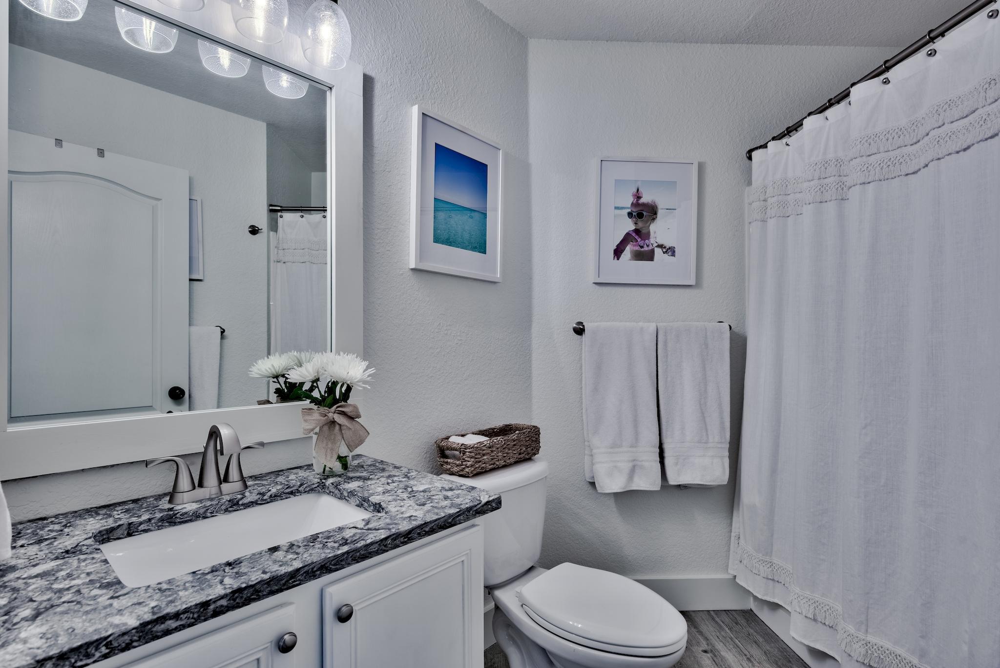 43 East Shipwreck Road Santa Rosa Beach, FL 32459 - Photo 26 of 40 a bathroom with a granite countertop sink mirror vanity and toilet