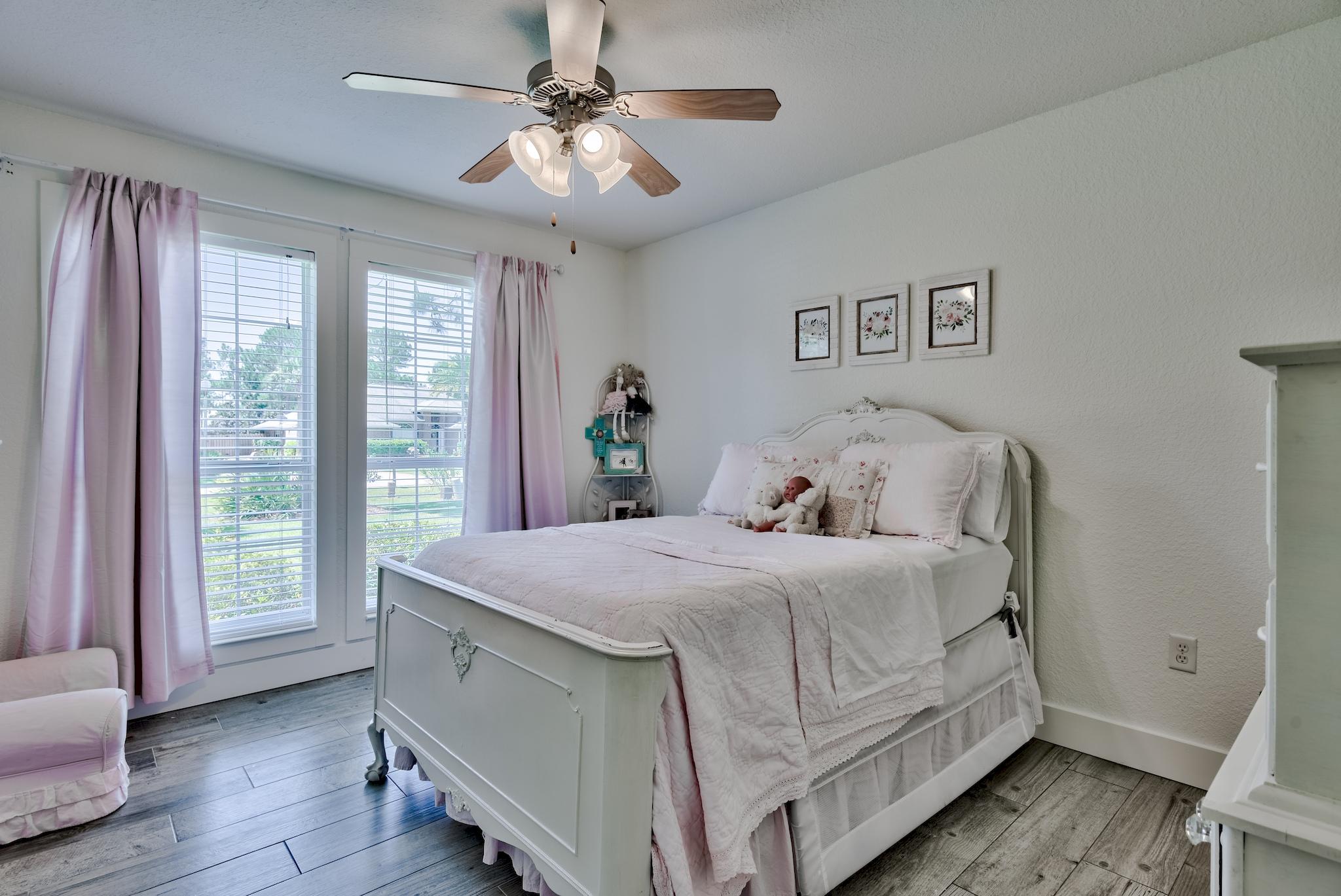 43 East Shipwreck Road Santa Rosa Beach, FL 32459 - Photo 27 of 40 a bed room with a bed and a chandelier