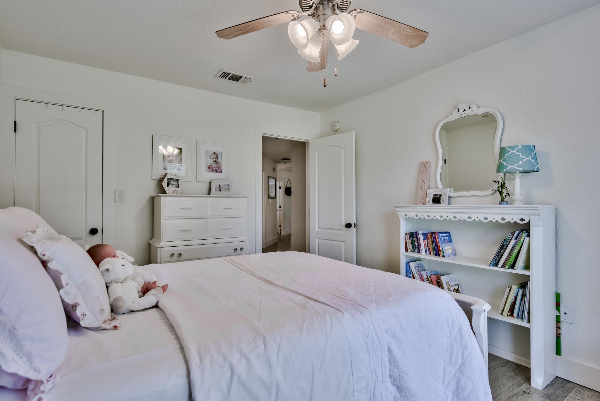 43 East Shipwreck Road Santa Rosa Beach, FL 32459 - Photo 28 of 40 a bedroom with a bed and a chandelier