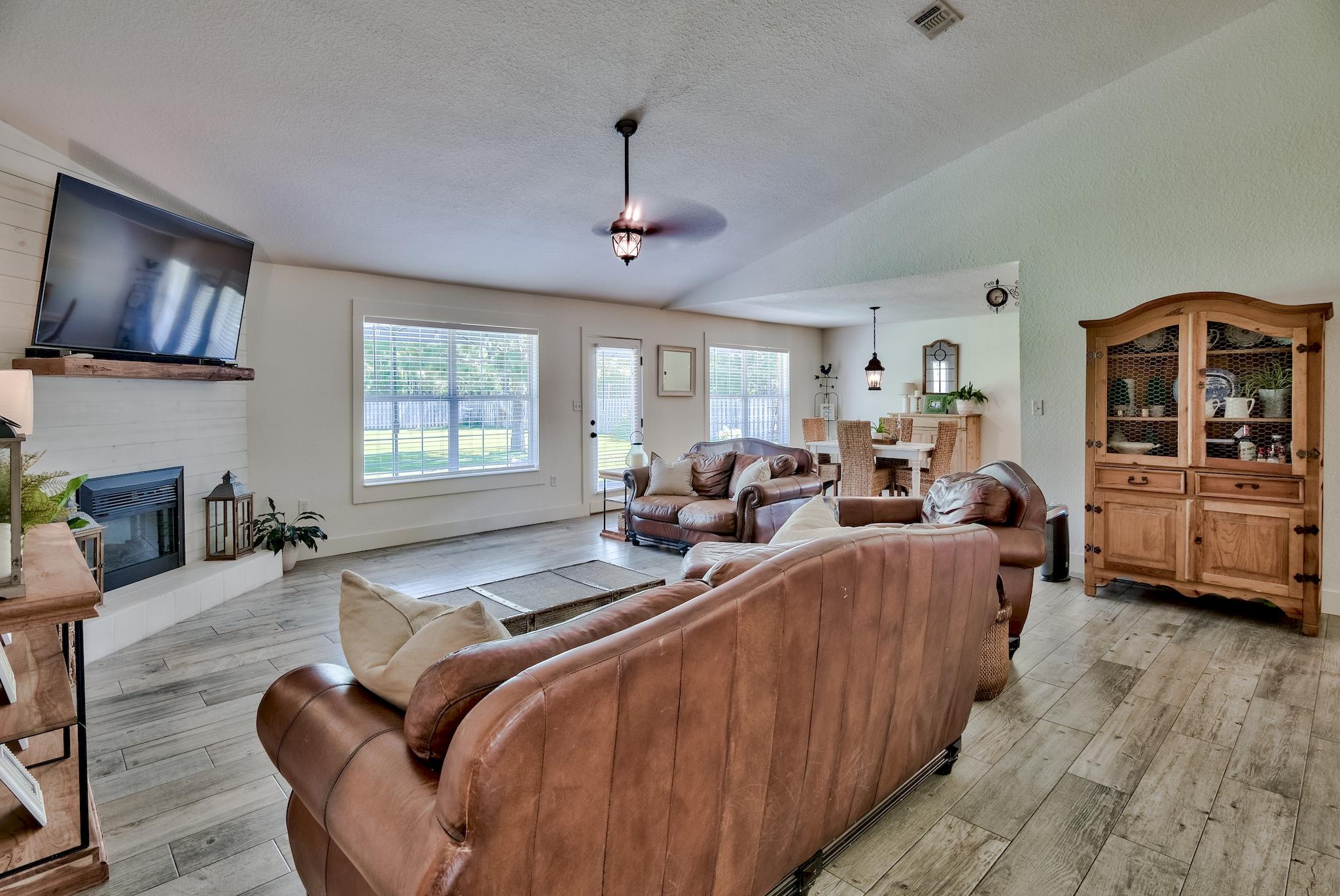 43 East Shipwreck Road Santa Rosa Beach, FL 32459 - Photo 3 of 40 a living room with furniture a chandelier and a flat screen tv