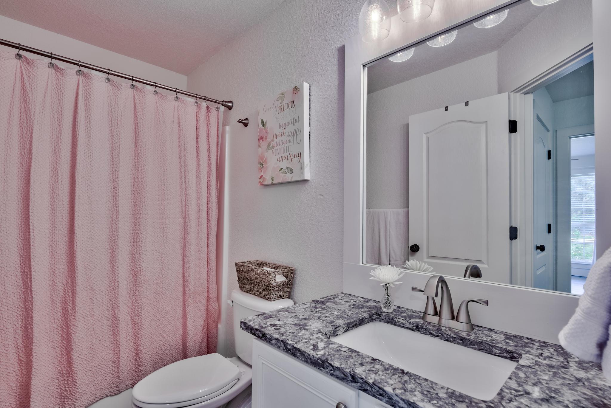 43 East Shipwreck Road Santa Rosa Beach, FL 32459 - Photo 31 of 40 a bathroom with a granite countertop sink and a mirror
