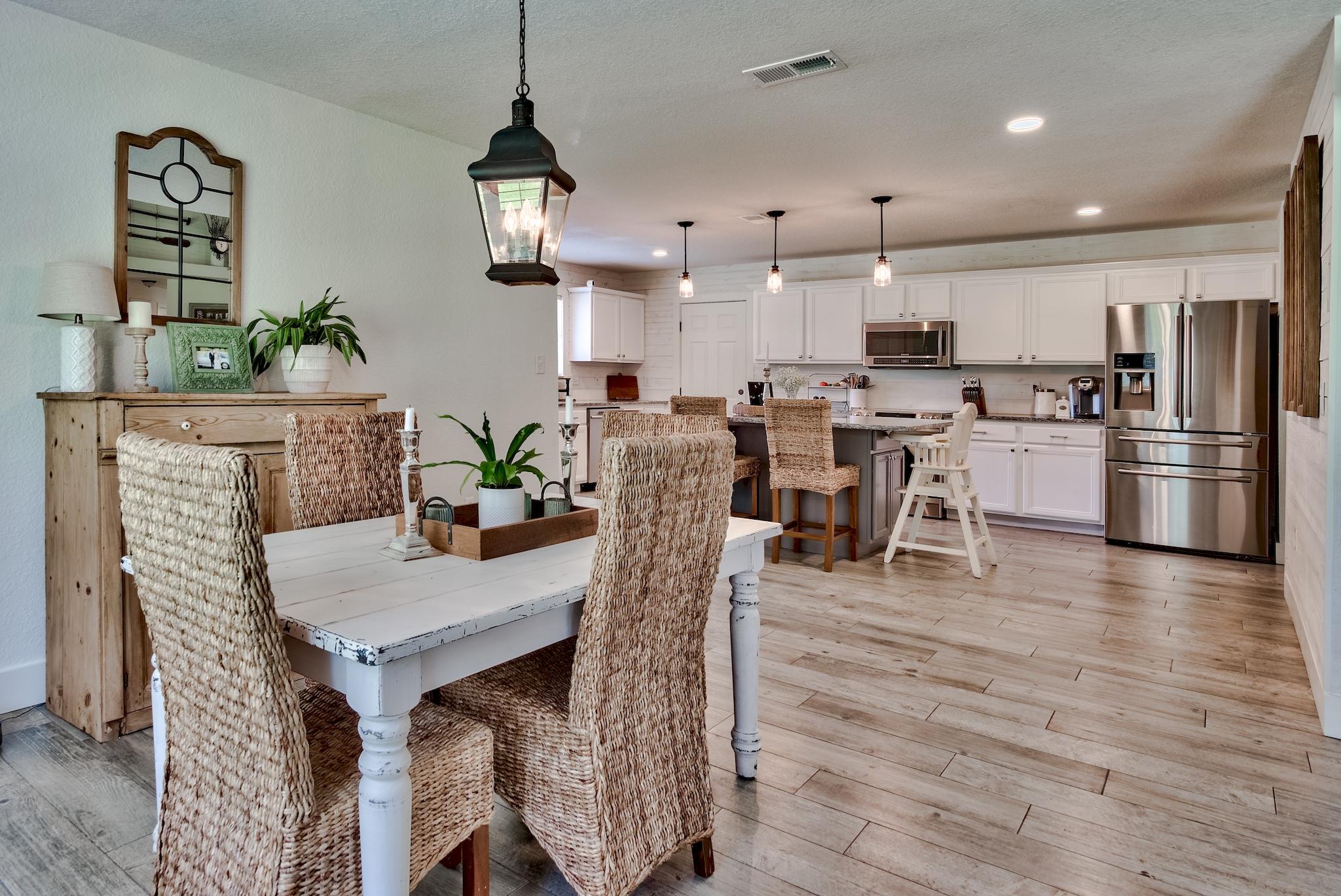 43 East Shipwreck Road Santa Rosa Beach, FL 32459 - Photo 7 of 40 a view of a dining room with furniture wooden floor and chandelier