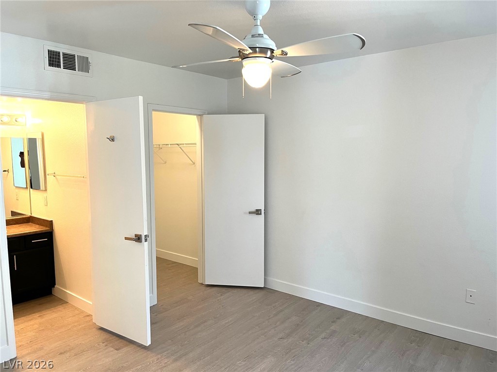 A spacious bedroom features direct access to an en suite bathroom and a walk-in closet.