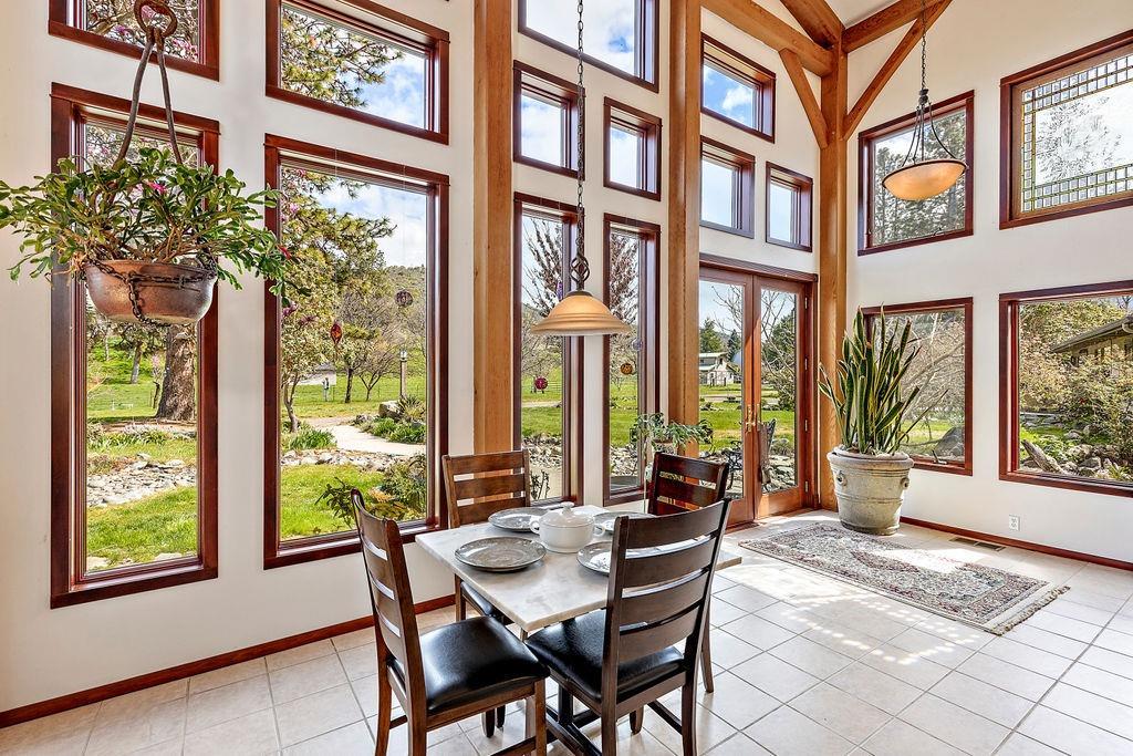 2076 Upper Applegate Road Jacksonville, OR 97530 - Photo 11 of 35 a view of a dining room with furniture and windows