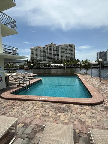 a view of a swimming pool with outdoor seating